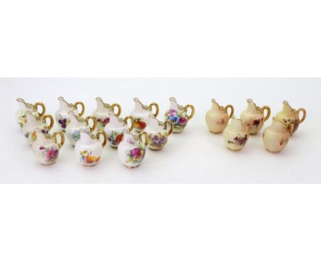A group of seventeen Royal Worcester miniature jugs, various dates, painted with flower and fruit, puce and black printed mar