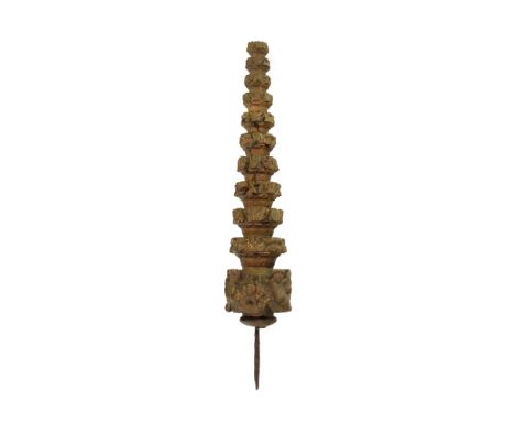 A giltwood tiered finial, 19th century, carved with masks, flowerheads and leaves with a lower band of amorini, 46cm high.