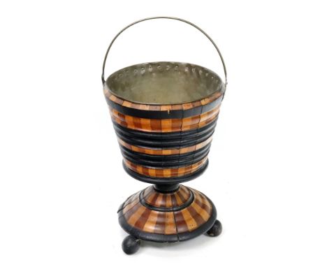 A Dutch ebonised walnut and satinwood bucket, first half 19th century, with ribbed sides, on a turned pillar and spreading ci