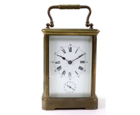A large brass cased carriage clock, circa 1900, the white enamel dial with Roman and Arabic numerals, with alarm and striking