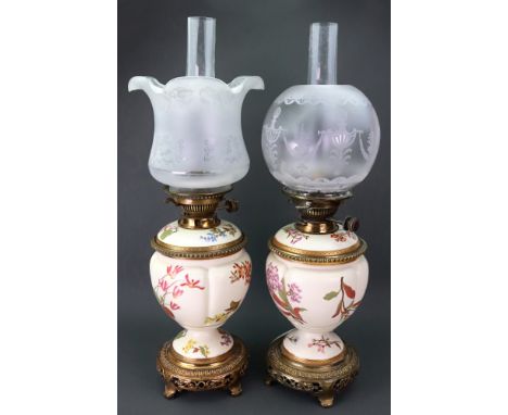 A pair of Royal Worcester gilt metal mounted oil lamps, late 19th century, each painted with scattered flowers against an ivo