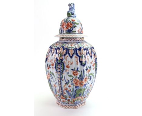 A Dutch Delft 'Cashmire' palette vase and cover, 19th century, of ribbed ovoid form, painted with panels of a bird amongst fl