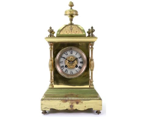 A late 19th century brass cased architectural style mantel clock, the arched top with turned and cast finials, having freesta