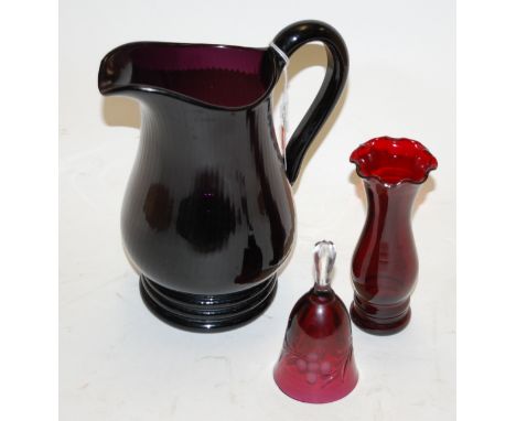 An amethyst glass picther together with a glass beaker, table bell, and vase (3)