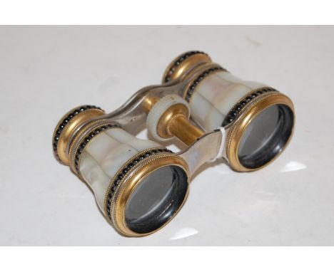 A cased pair of W Gregory of The Strand, London, brass and mother of pearl opera glasses with original leather carry case, an