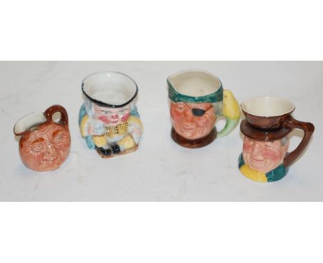 A Clarice Cliff miniature Toby jug printed mark verso together with two Lancaster Sandland character jugs, and one Royal Doul