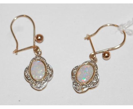 A pair of yellow metal, cabochon opal and diamond point set ear pendants