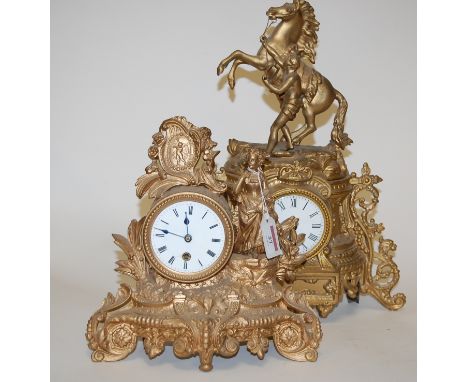 A late 19th century French gilt metal cased mantel clock having an enamel dial with Roman numerals surmounted by a rearing ho