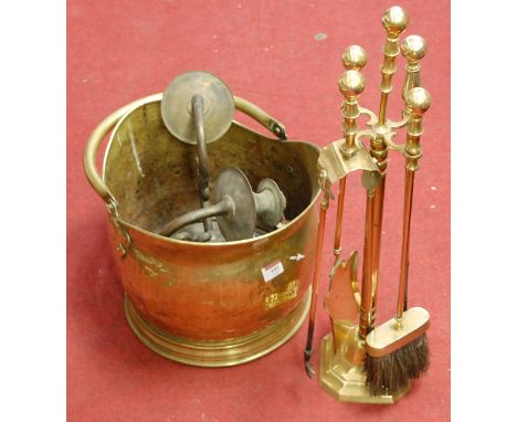 An early 20th century brass helmet shaped coal scuttle together with a brass twin sconce wall light fitting and brass compani