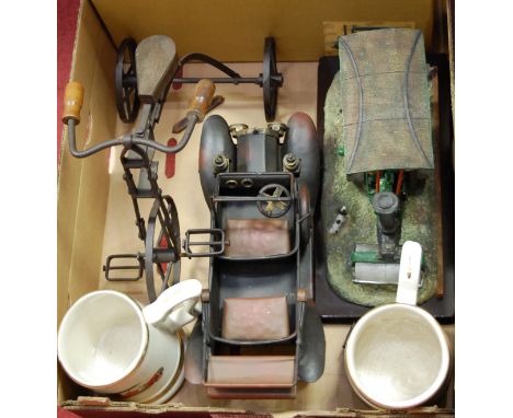 A reproduction tinplate model of a steam roller together with one other resin model of a steam roller, model tricycle, two ta