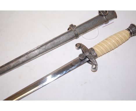 A reproduction German dress dagger, the 23.3cm double edge blade stamped FW Holler Solingen having a Swastika cross guard and