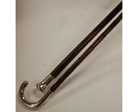 A circa 1900 walking cane having a faux bamboo shaft and silver mounted handle, together with one other silver mounted walkin