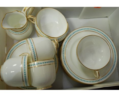 A Victorian part tea service on a plain white ground within a turquoise beaded and gilt border