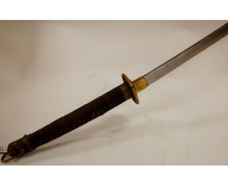 A reproduction Japanese shin gunto katana having curved steel blade, pierced brass tsuba, and leather bound grip in brass mou