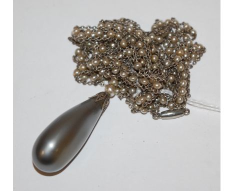 A 1920s grey pearl pendant on seed pearl set and white metal neck chain