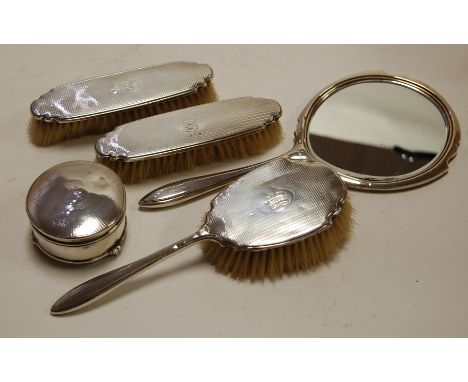 A George V four piece silver backed dressing table set, with engine turned decoration, by Adie Brothers, Birmingham 1931; tog