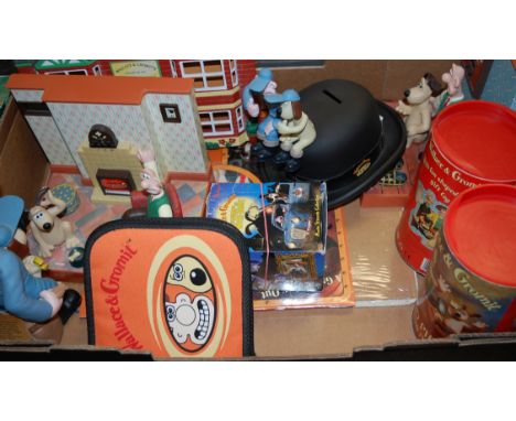 A box of assorted Wallace & Grommit figures and accessories to include moneybox, novelty alarm clock, jigsaw puzzles etc