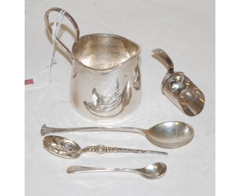 Assorted silver and white metal wares to include cream jug, sugar caddy shovel, and three various spoons (5)