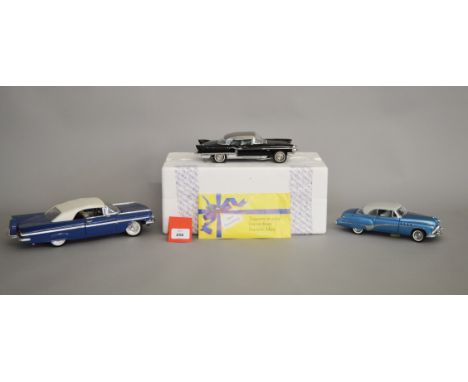 Two boxed Franklin Mint diecast models in 1:24 scale, a 1957 Cadillac Eldorado  and a 1953 Eldorado model in white, both appe