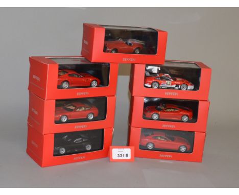 Seven boxed IXO Ferrari diecast model cars in 1:43 scale including 125S, F430 and 575M Maranello variants. All appear VG in G