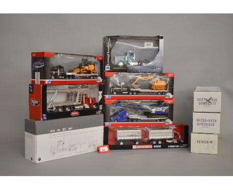 Ten boxed diecast truck models by Maisto, New Ray, First Gear and others, including a Peterbilt 379 model Vehicle Carrier in 