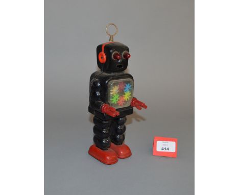 Yoshiya (Japan) High Wheel Robot, black clockwork tinplate robot with red tinplate feet and red plastic hands, clear chest re