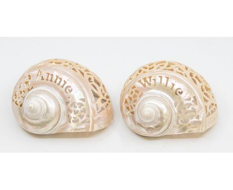 A pair of early 20th Century carved mother of pearl shells with names etched within