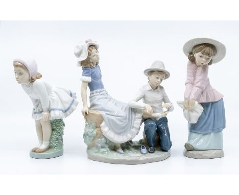 three Nao figures, boy and girl pair and two young girls