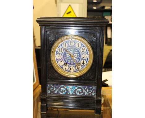 A late 19th Century aesthetic slate bracket clock, having a white enamelled dial, eight day movement, with two winder holes, 