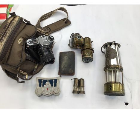 A collection of miners lamps, brass car lamp, collection of coins, camera and a collection of 78's records