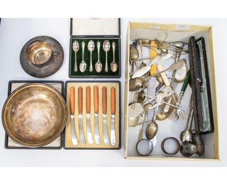 A collection of plated items including boxed bread knife, mother of pearl plated cup and saucer, napkin rings, flat ware etc