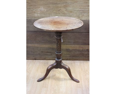 A George III mahogany tripod table, raised on a turned column, standing on three cabriole legs, 69cm high, 49cm in diameter