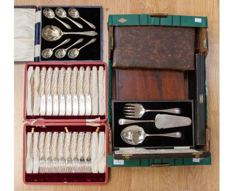A box containing various cutlery sets, comprising cake knife and fork set, set of dessert spoons, fish knife and fork server 