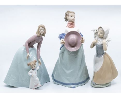 Three Nao lady figures, one with child and the another with lamb