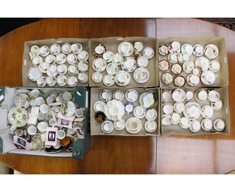 A collection of assorted miniature cups and saucers, various designs and factories, including Coalport, RCD, Wedgwood, Japane