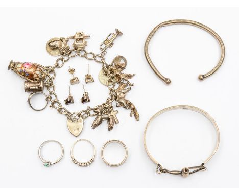 A collection of silver jewellery including a silver charm bracelet, a silver bangle, a white metal bangle, etc, 96.8grams/3.1
