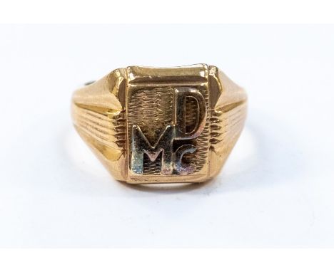 A 9ct gold signet ring, square head with applied letter DMC, diameter approx 15mm, size Z+2, weight approx 21.6gms&nbsp;