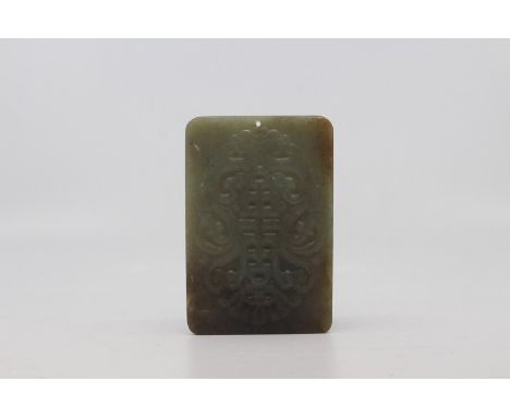 A mid mottled green and russet jade archaistic pendant plaque, probably Republic period, of rectangular form and carved to ea