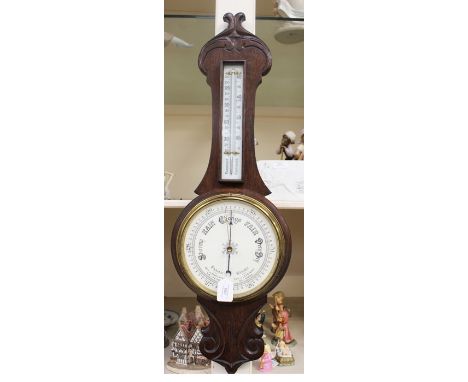 An early 20th Century oak banjo barometer and thermometer, carved case