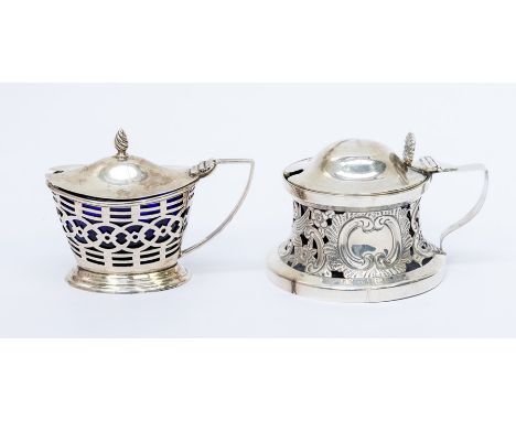 An Edwardian silver large mustard pot and cover, the body spool shaped in the manner of an Irish dish ring, with scrolling de