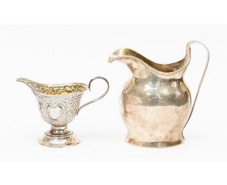 A George III silver helmet shaped cream jug, reeded rim, engraved with initials, London, 1815, makers' mark rubbed together w