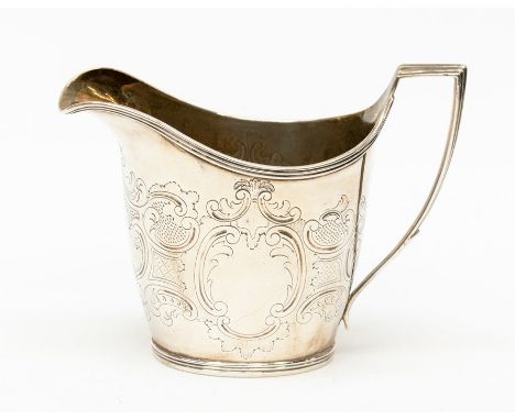 A George III silver helmet shaped cream jug, with chased scrolled decoration, plain cartouche, gilt interior, London 1803,  J