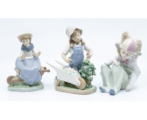Two Nao figures of girls with barrows and a Nao style clown