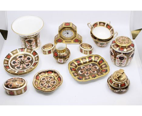 A collection of Royal Crown Derby 1128 Imari pattern including cup and saucers, ginger jars, vases, clock, lighter, pin/trink