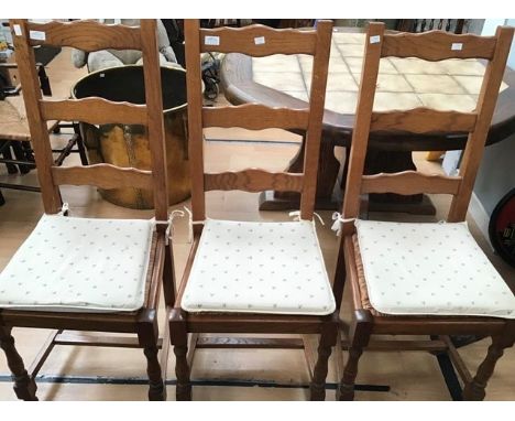 A set of six contemporary oak ladder back chairs with rush seats, together with a pair of contemporary beech framed rush seat
