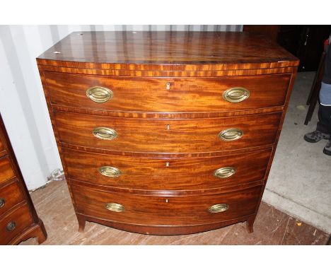 An early 19th Century mahogany bow fronted chest of drawers, fitted with four long graduated drawers, raised on bracket feet,