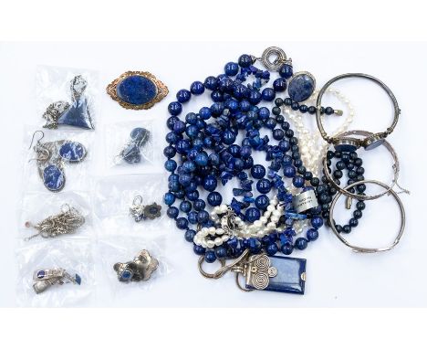 A collection of jewellery to include a silver/white metal set lapis lazuli bangle, earrings, ring and pendants with chains, a