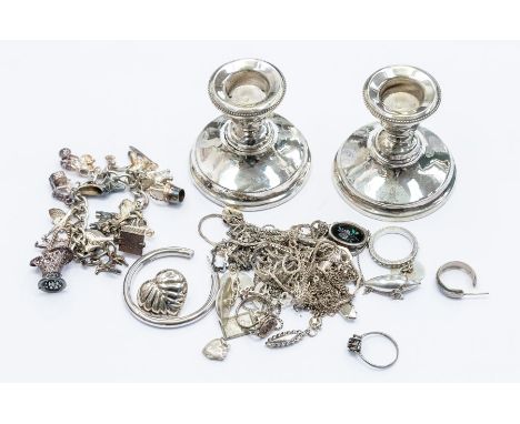 A collection of silver and white metal jewellery to include a charm bracelet with various charms to include elephant, flying 
