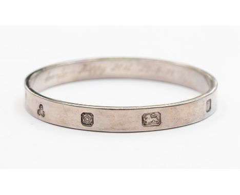 An Elizabeth II silver bangle of rectangular section, the outside with feature hallmarks, Sheffield 1993, GGL, polished, inte