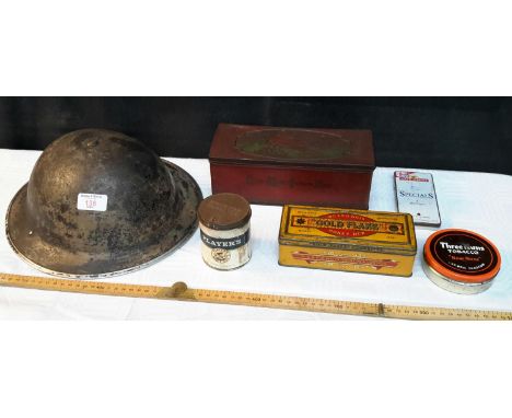 British military helmet together with old advertisement tins 